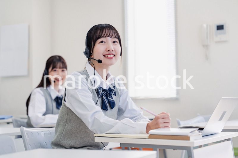 教室でノートパソコンを使う女子高生