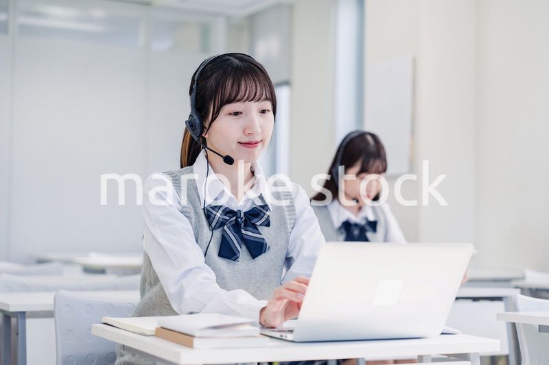 教室でノートパソコンを使う女子高生