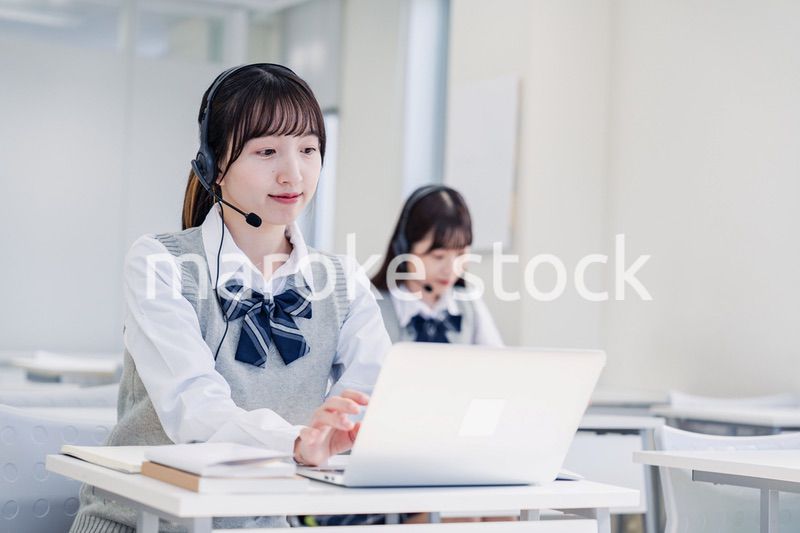 教室でノートパソコンを使う女子高生