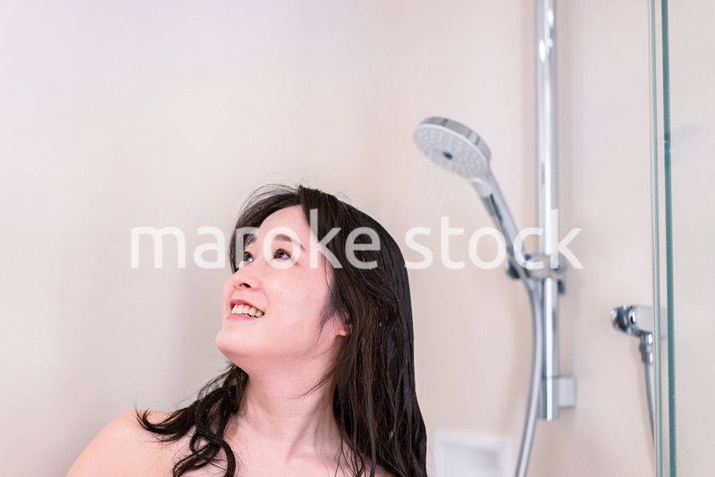 シャワーを浴びる若い女性