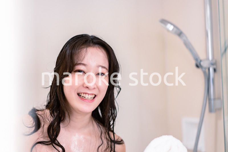 シャワーを浴びる若い女性