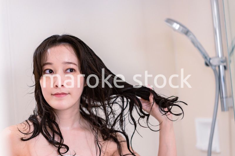 シャワーを浴びる若い女性