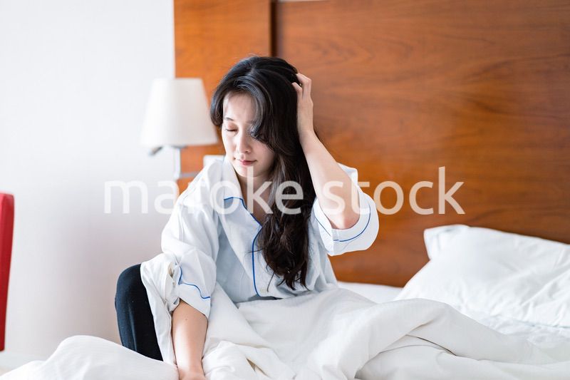 二日酔いに苦しむ若い女性