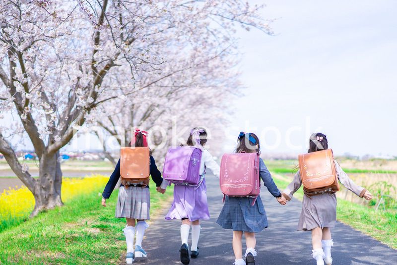 マスクをして小学校に登校する女の子たち