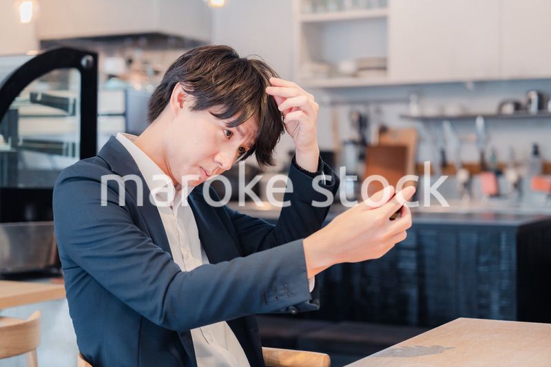 カフェで身だしなみを整える男性客