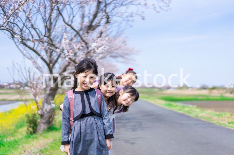 登下校中に通学路で遊ぶ小学生の女の子たち