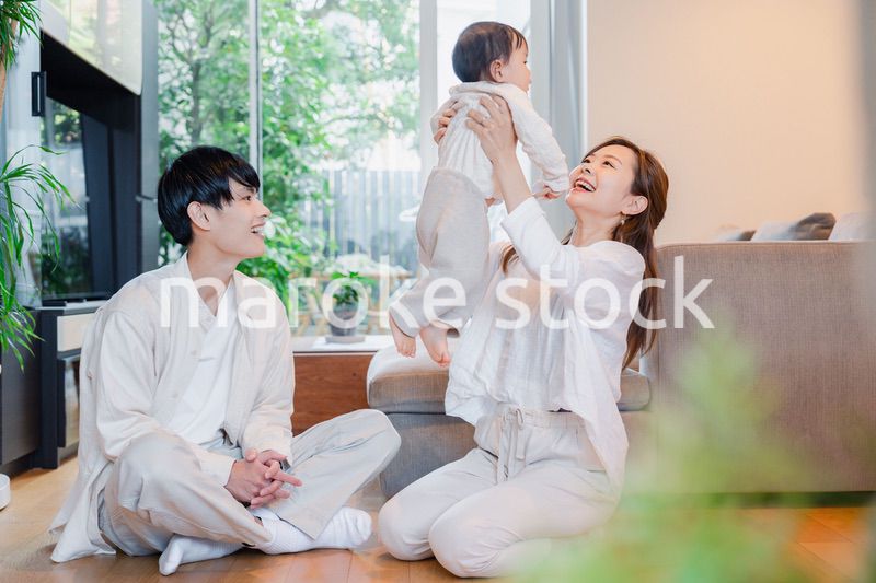 赤ちゃんと高い高いをして遊ぶファミリー