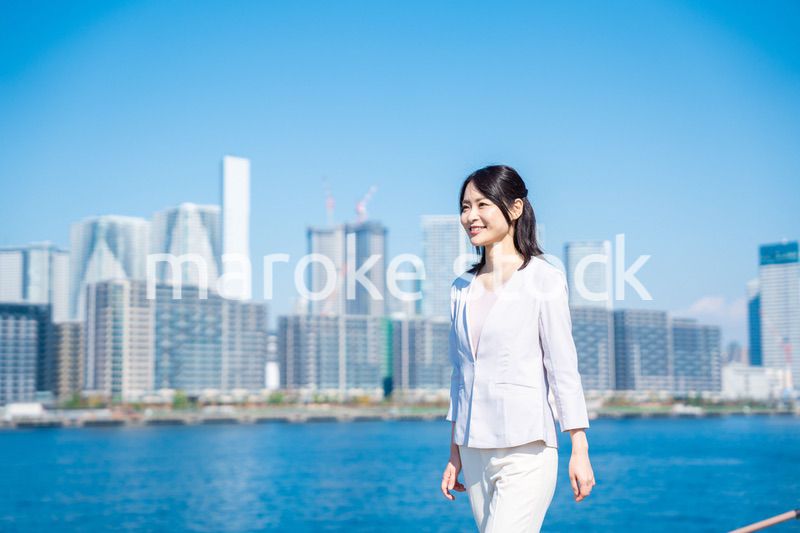 笑顔で外を歩くビジネスウーマン