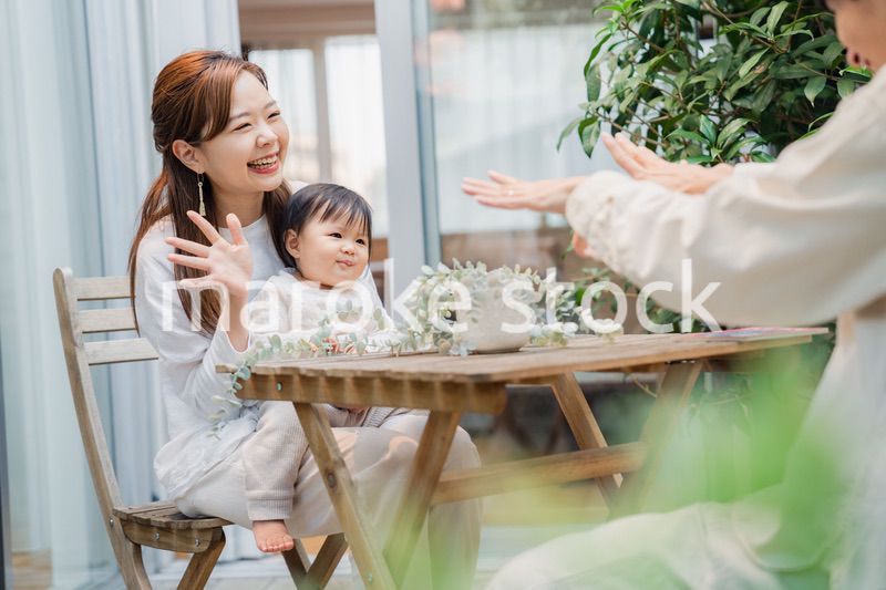 おうちのテラスで赤ちゃんと過ごす家族