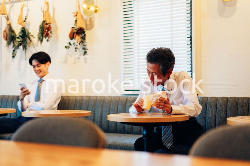 ハンバーガーショップでランチを食べるビジネスマン
