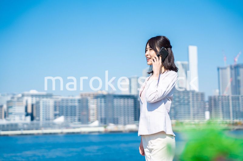 笑顔で外を歩くビジネスウーマン