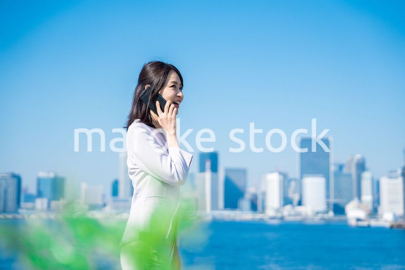 笑顔で外を歩くビジネスウーマン