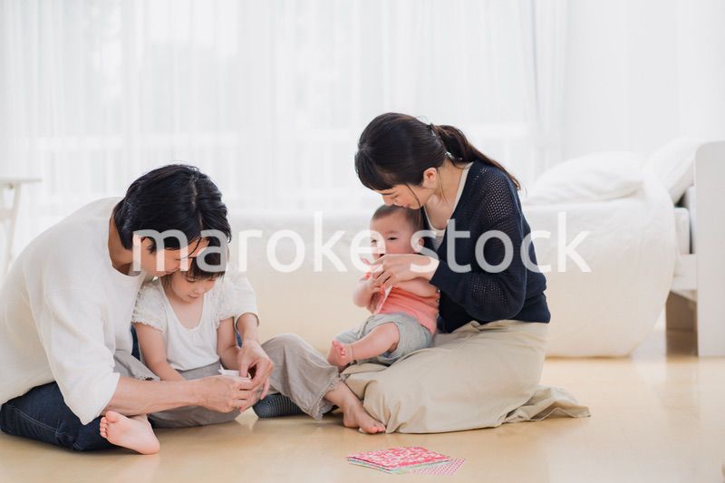 お家で折り紙遊びをする家族