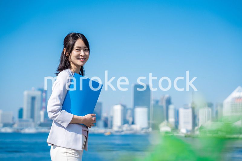 書類を持って外を歩くビジネスウーマン