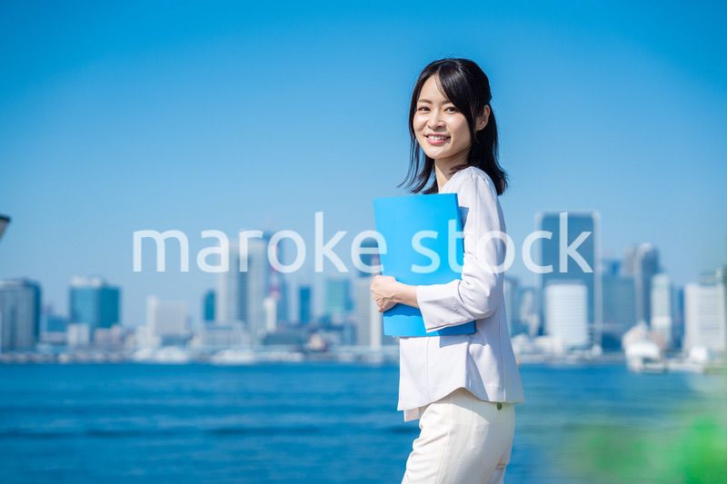 書類を持って外を歩くビジネスウーマン