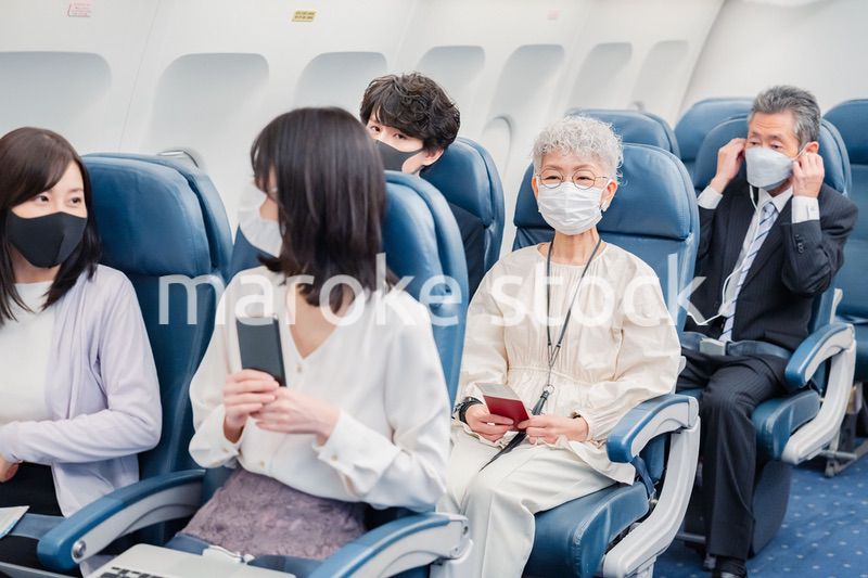 飛行機の機内で過ごす乗客