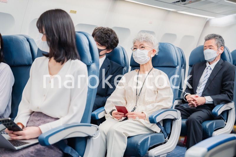 飛行機の機内で過ごす乗客
