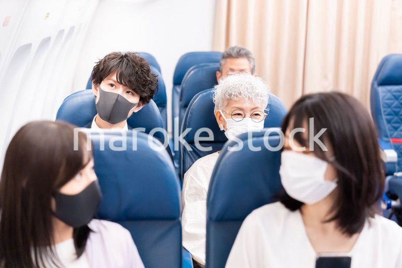 マスクをして飛行機に乗る乗客