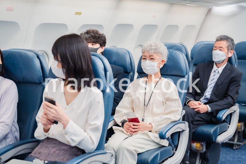 飛行機の機内で過ごす乗客