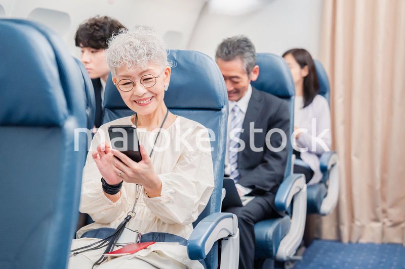 飛行機の機内で過ごす乗客