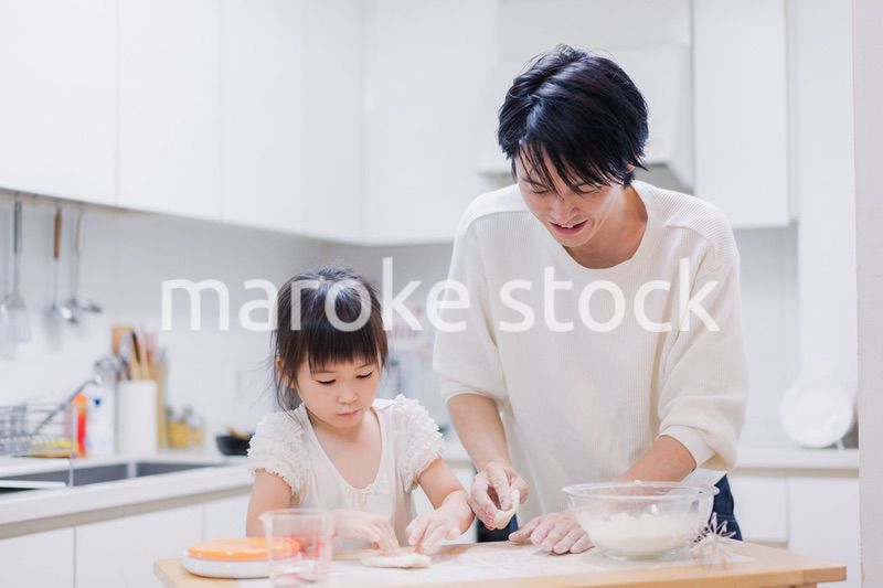 娘と生地をこねるパパ