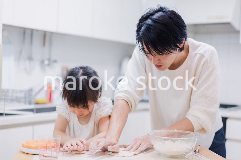 娘と生地をこねるパパ