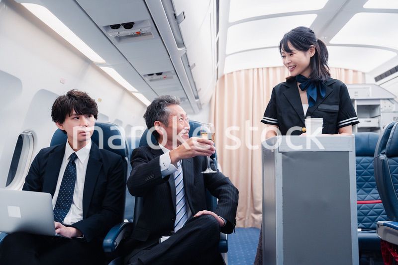 機内で飲み物を提供するキャビンクルー
