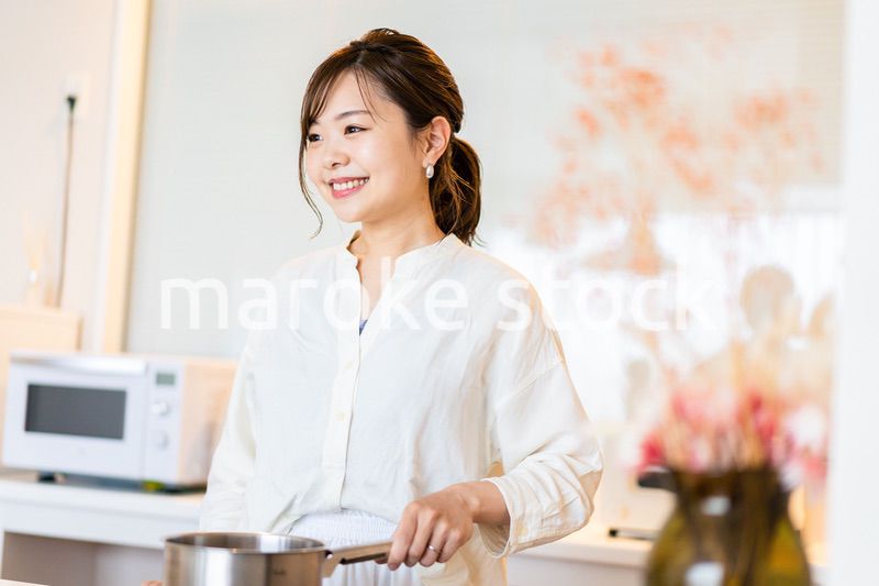 おうちのキッチンで料理をする主婦