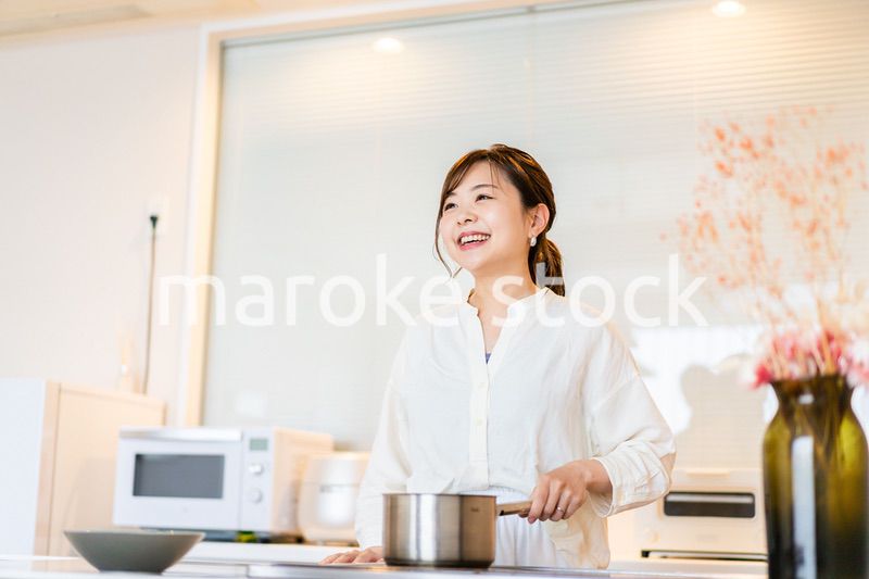 おうちのキッチンで料理をする主婦