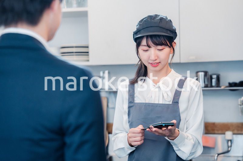 カフェでクレジットカード決済をする男性客