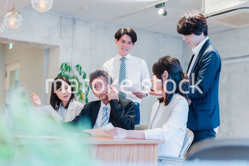 明るいオフィスに勤務をするビジネスパーソン