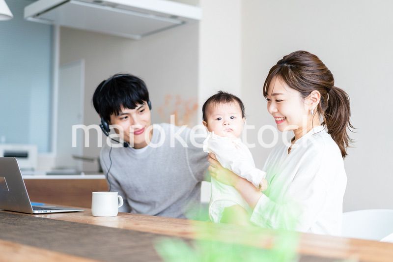 在宅勤務をするお父さんと子育てをするお母さん