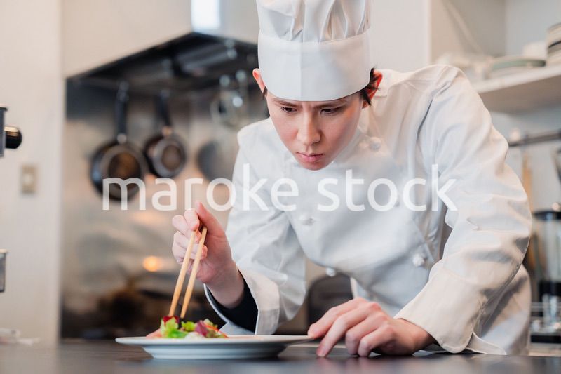 料理の盛り付けをする男性シェフ