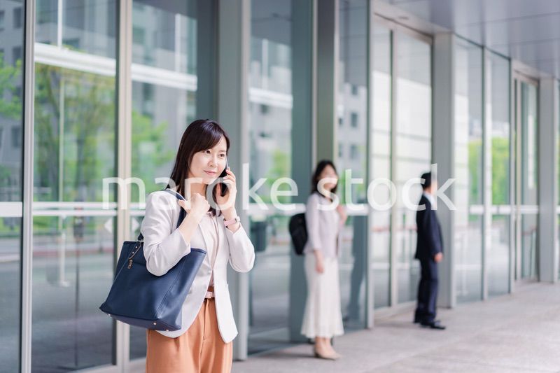 笑顔でスマホを使うビジネスウーマン