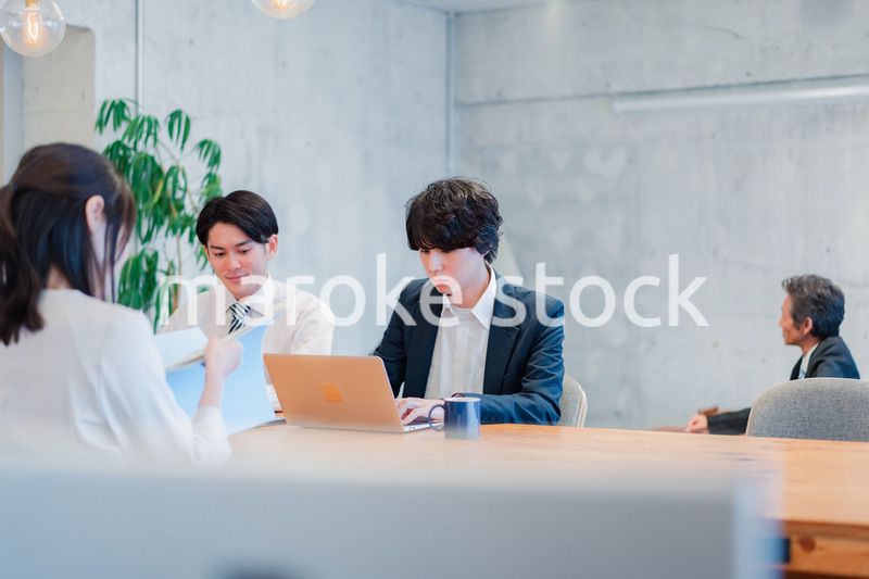 明るいオフィスに勤務をするビジネスパーソン