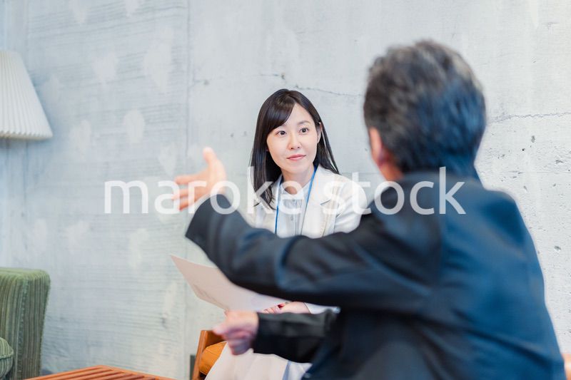 ビジネスマンに保険の勧誘をする営業の女性