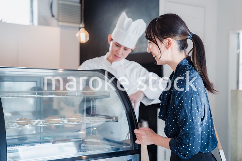 お店でスイーツを選ぶ若い女性
