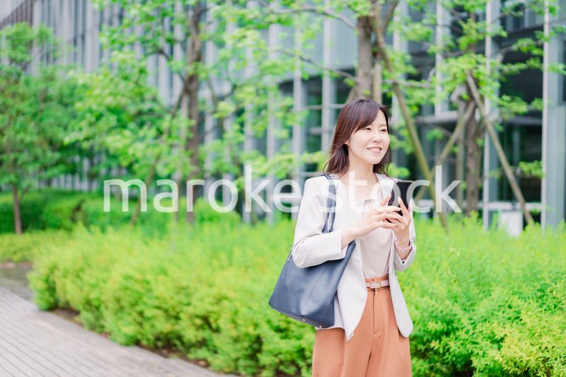 歩きスマホをするビジネスウーマン