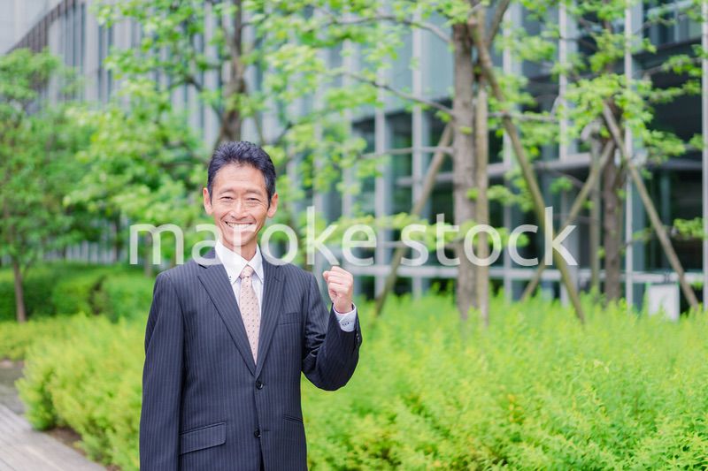 ガッツポーズをする高齢のビジネスマン