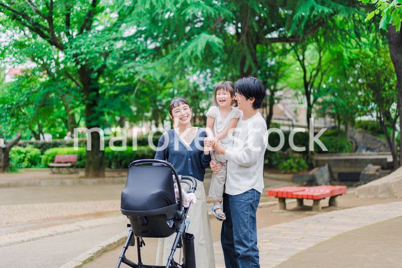ベビーカーを押しながら散歩する家族