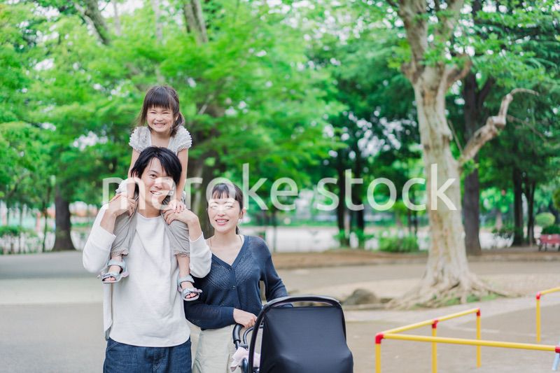 子供と一緒に公園を散歩する家族