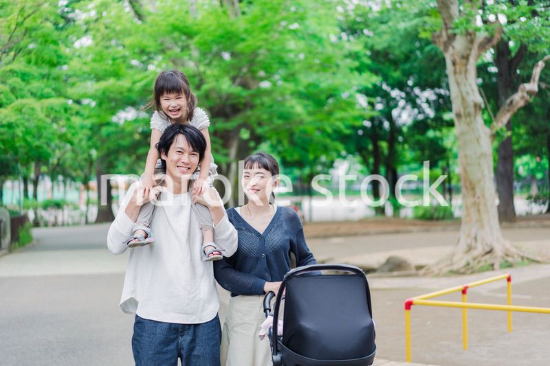子供と一緒に公園を散歩する家族