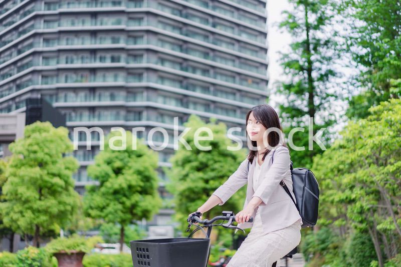 シェアサイクルで通勤をするビジネスウーマン