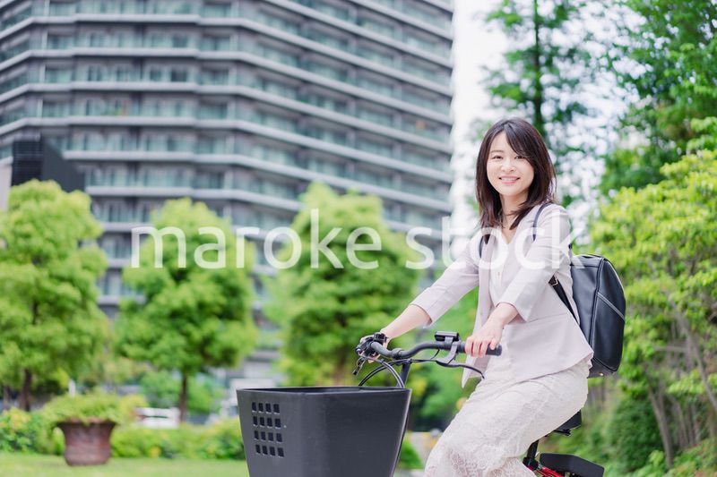 シェアサイクルで通勤をするビジネスウーマン