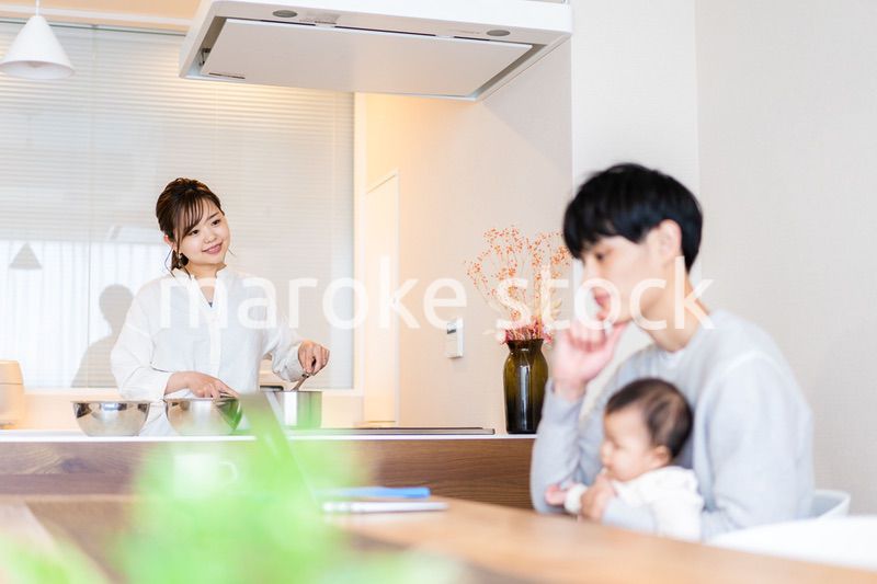 赤ちゃんと一緒にパソコンを使うパパ