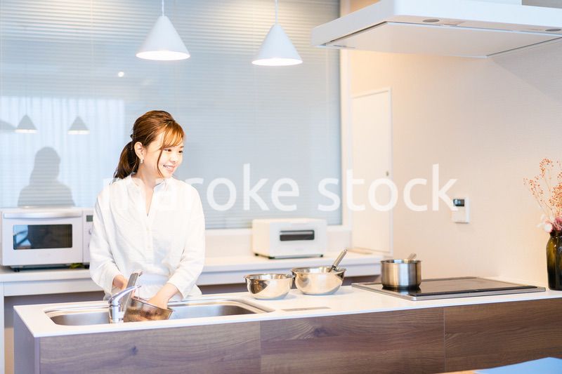 おうちのキッチンで料理をする主婦