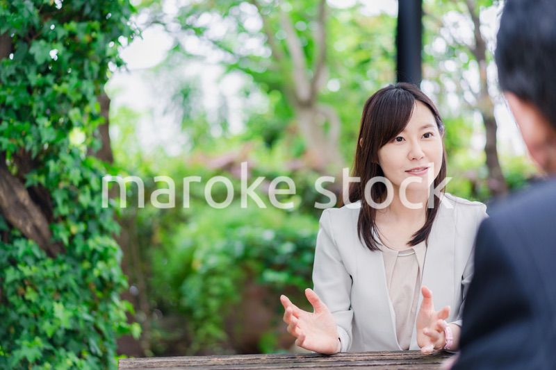 屋外で意見交換をするビジネスウーマン