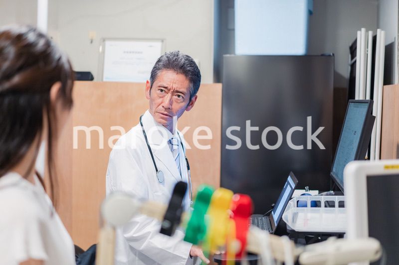高齢の医師と患者