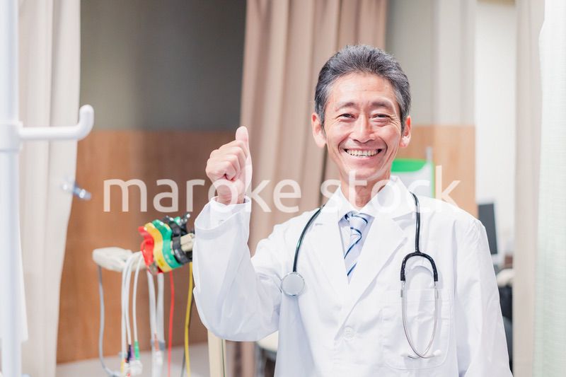 グッドサインをするベテランのドクター