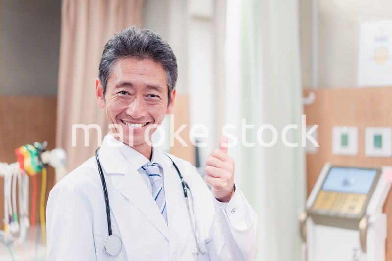 グッドサインをするベテランのドクター